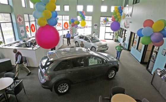 In this April 21, 2010 file photo, customers are seen in the showroom at the Formula Ford dealership in Montpelier, Vt.